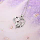 Silver necklace with a footprint and heart, set with zirconia.