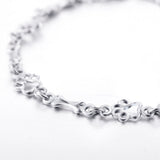 Silver bracelet with dog paw prints and a bone
