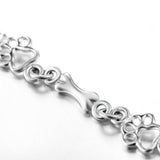 Silver bracelet with dog paw prints and a bone