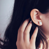 Silver earrings with a pearl and cat motif