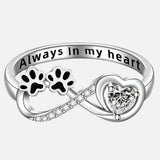 Ring with an open heart and an infinity symbol.