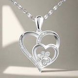 Silver necklace with a footprint and heart, set with zirconia.